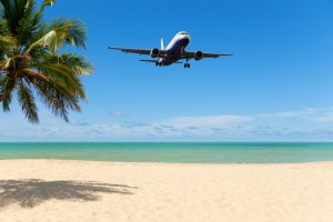 Airplane to tropical beach summer vacation